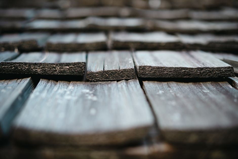 Close-up of asphalt roof shingles with texture detail showing professional material quality
