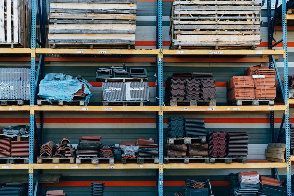 Roofing materials and installation tools professionally arranged on wooden surface with measured precision